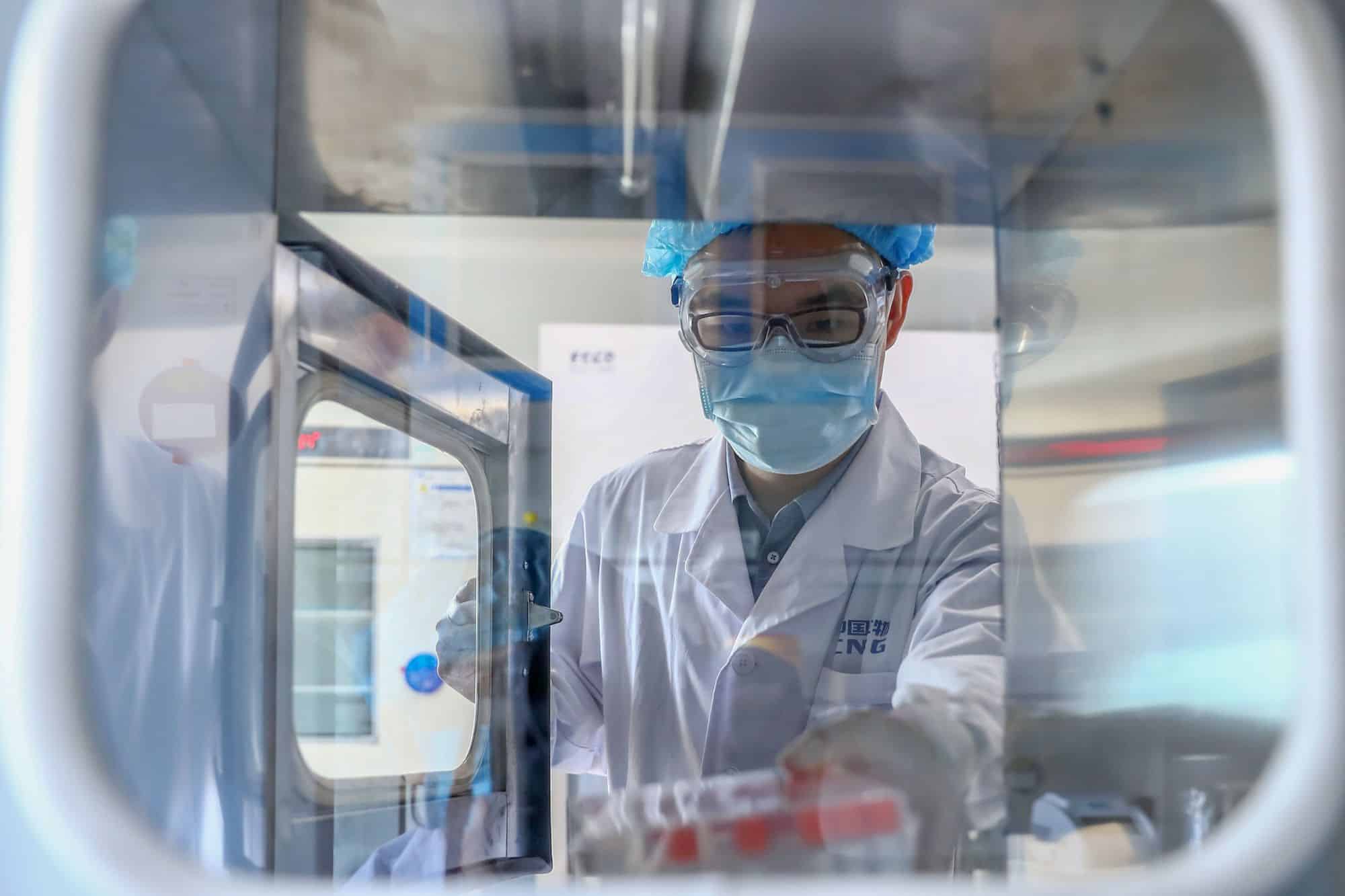 A staff member takes out samples of the COVID-19 inactivated vaccine at a vaccine production plant in Beijing, in April 2020.
