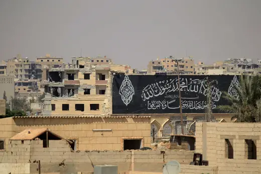 A banner belonging to Islamic State fighters is seen during a battle with members of the Syrian Democratic Forces in Raqqa, Syria, on August 16, 2017.